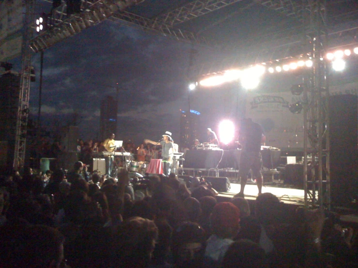 the stage with people watching as the band perform