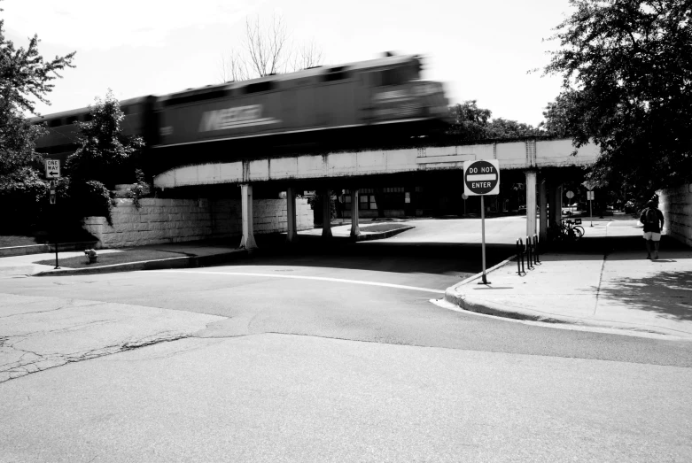 a train moves over an overpass on a sunny day