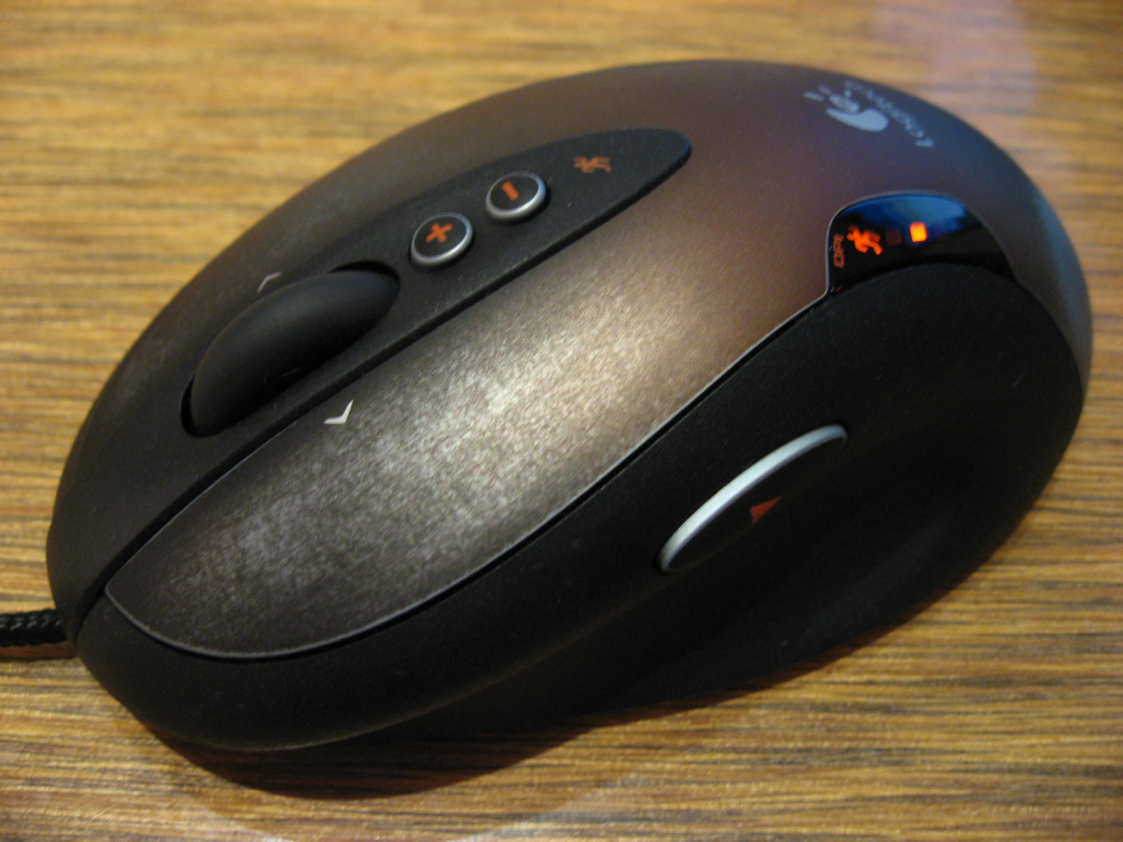 a wireless mouse that is on a wooden table