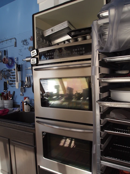 silver appliances are stacked in a modern kitchen