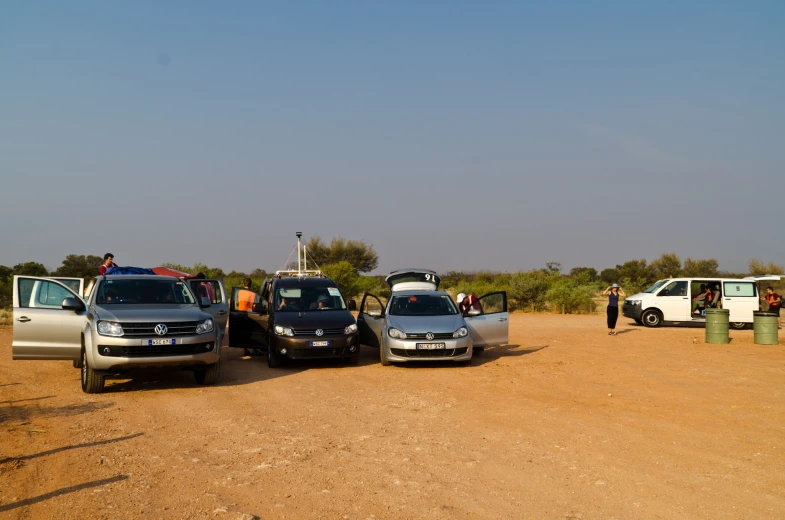 a group of suvs parked next to each other in the dirt