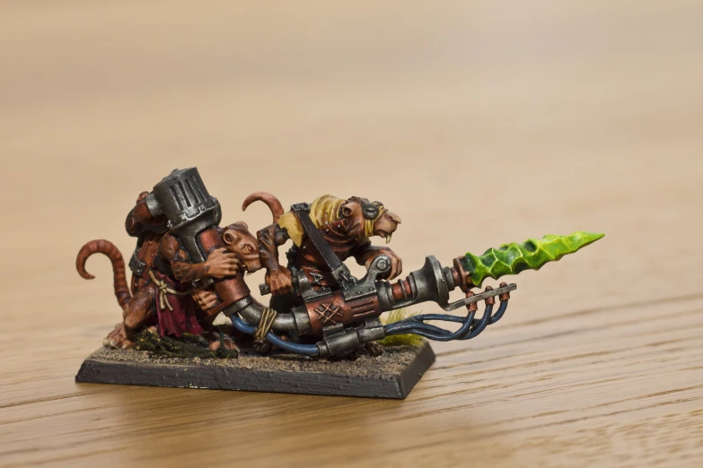 a wargamer with four small heads and green spear on a table