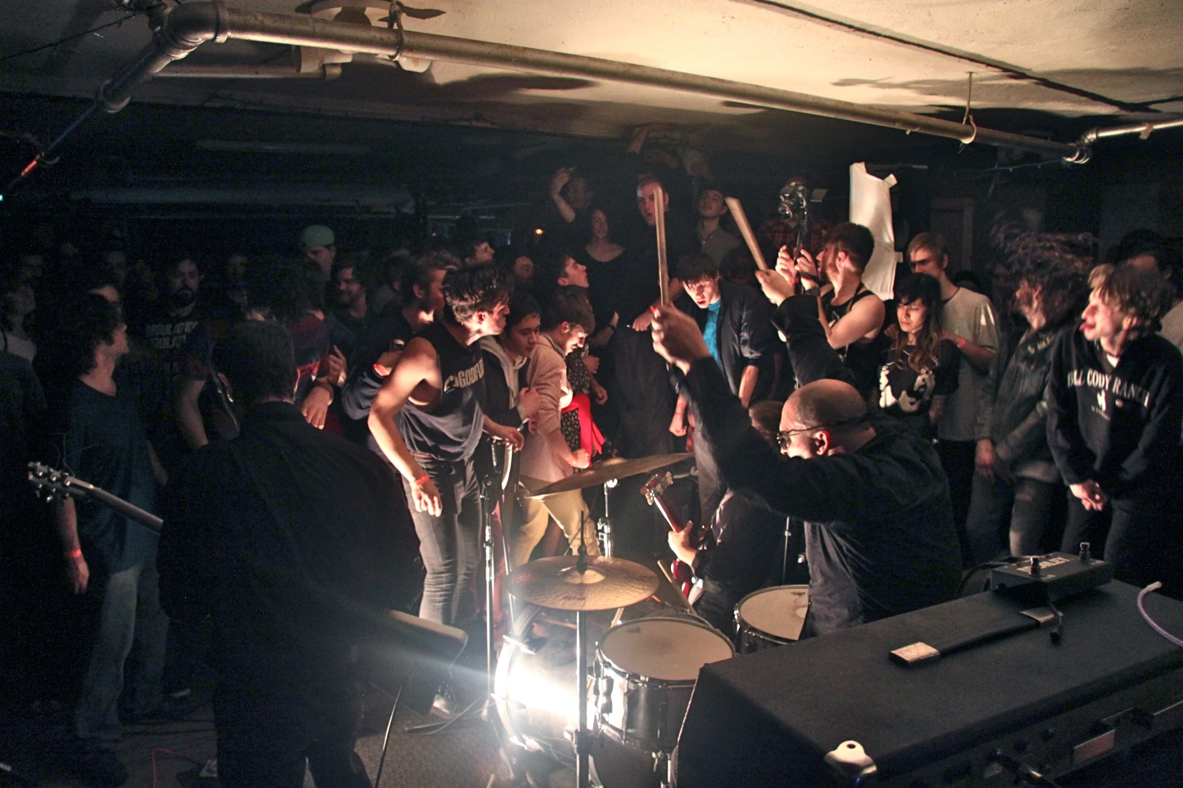 a group of people in a club, all clapping