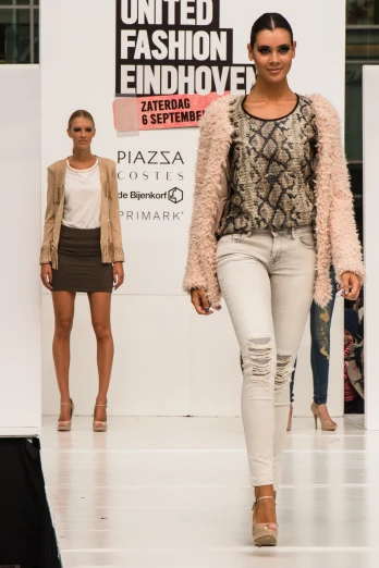 two women are on the runway in clothes