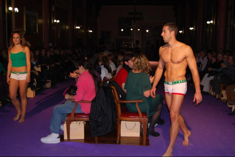 a male and female are sitting in an audience at a show