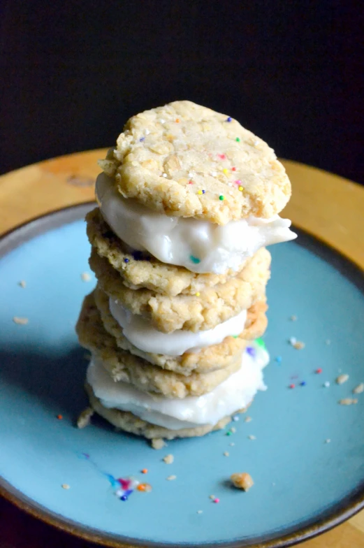 a stack of three ice cream sandwiches with sprinkles