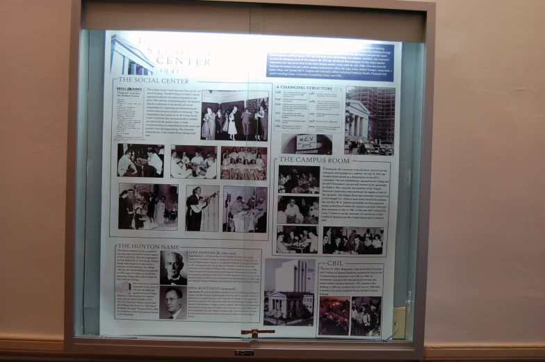 a display case with several pieces of newspaper showing events