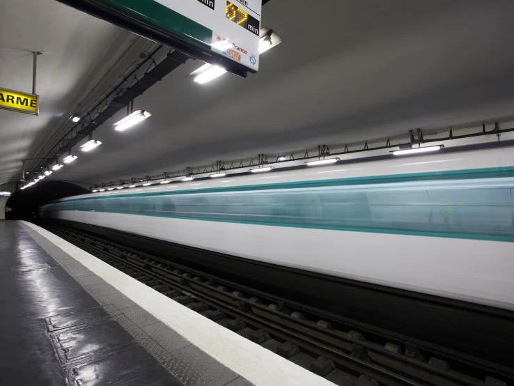 a train drives through a station in the dark