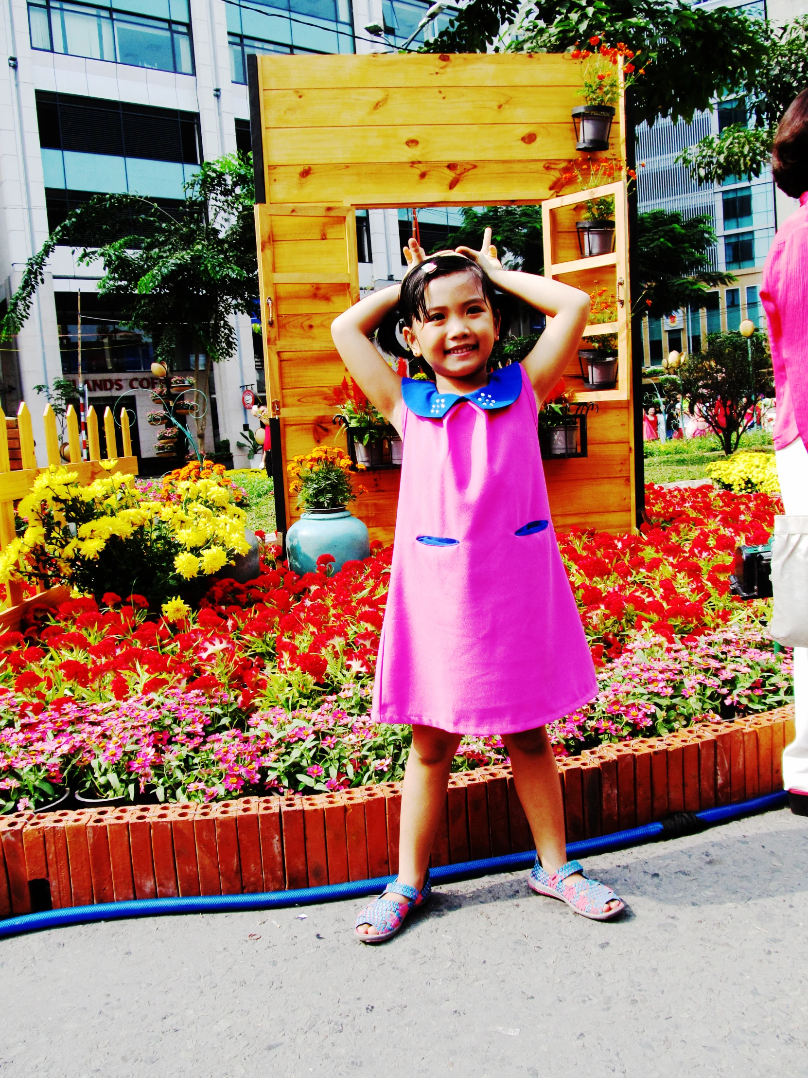  in pink dress with hands behind head