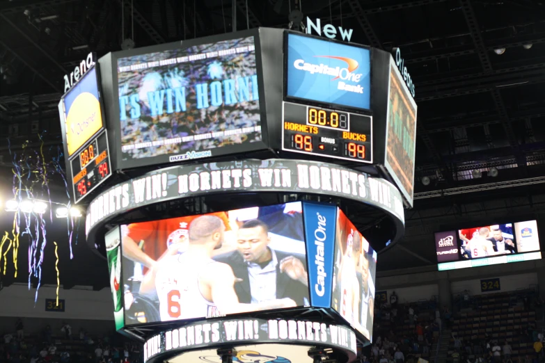 a large crowd watching television at a sports game