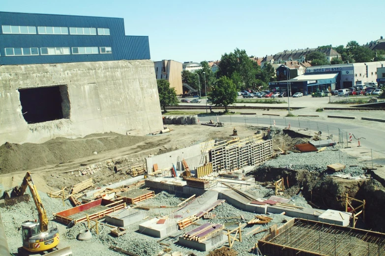 construction on a street with some vehicles parked outside