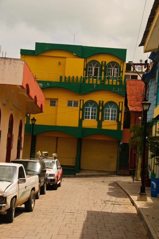 several vehicles parked in front of a multi - colored building