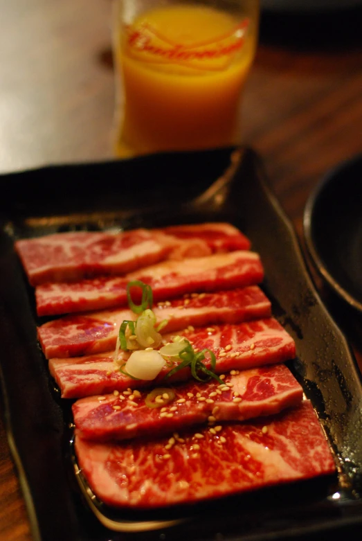 an image of meat being prepared on the grill