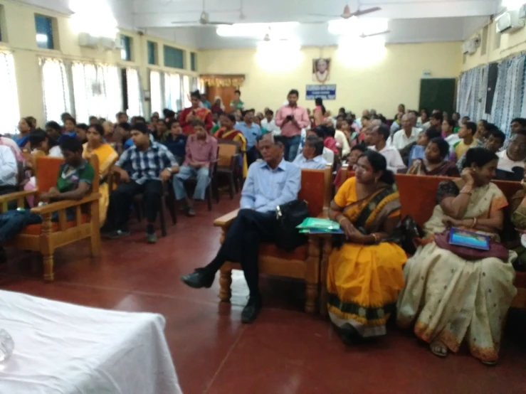 a room full of people with one person on a computer