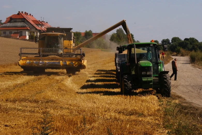 tractor and combine harvester combine grain from a large field