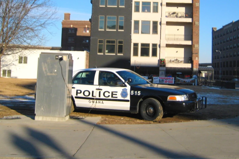 a police car parked next to a street sign