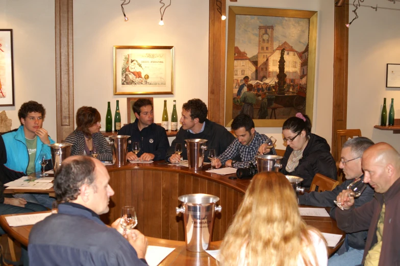 group of people enjoying an old - fashioned speak on the bar