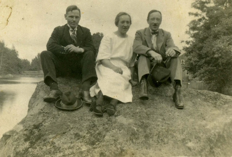 a black and white po of three people