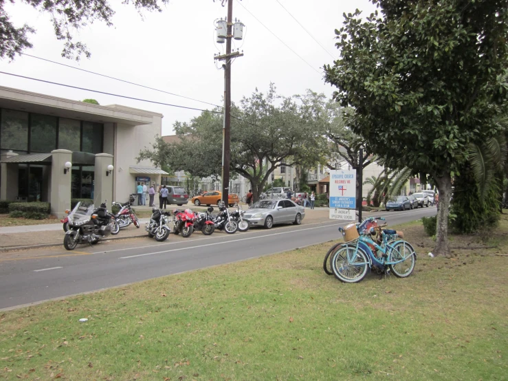 the group of motorcycles are parked in the street