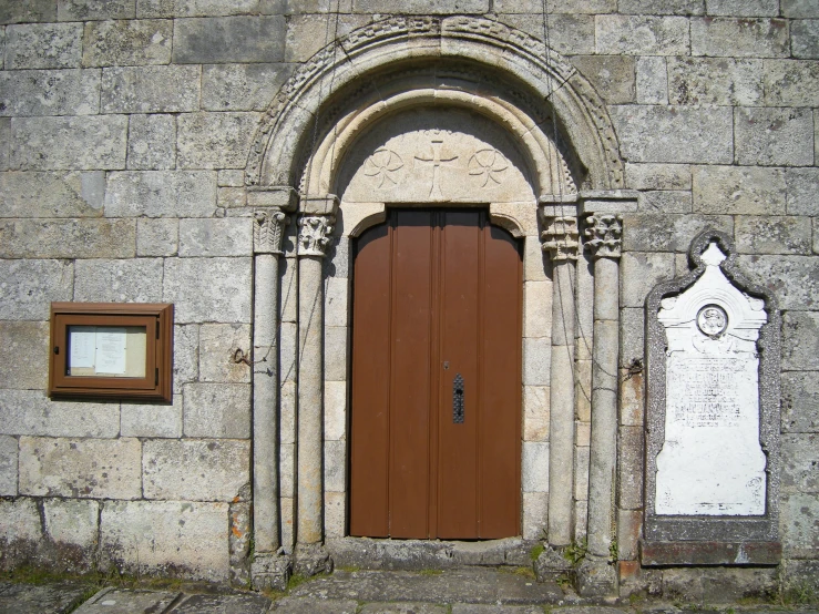 a brown door sitting in the center of a wall