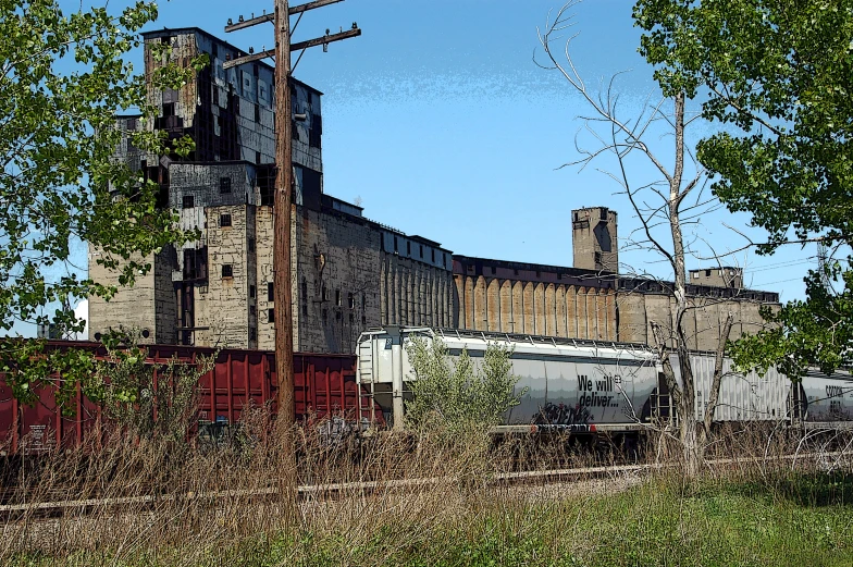 a train going by an old building with brick walls