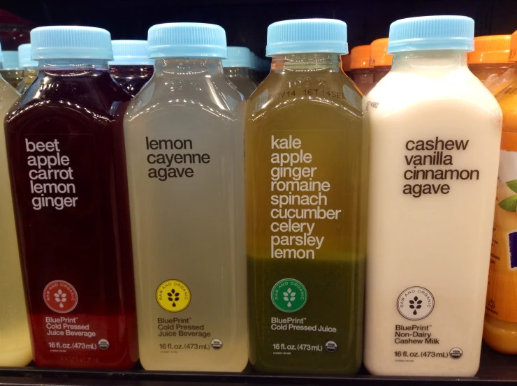 many different juices lined up in a row