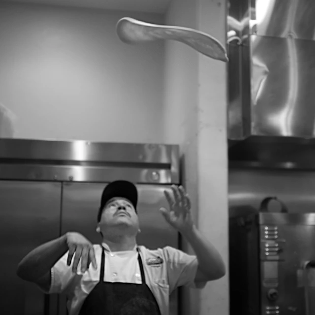 a young man in the kitchen waiting to get food out