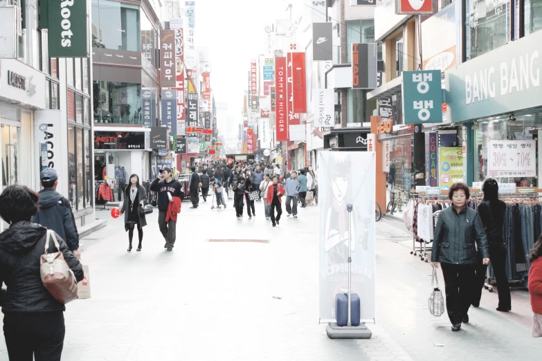 a city street with people on it with signs, buildings and advertits