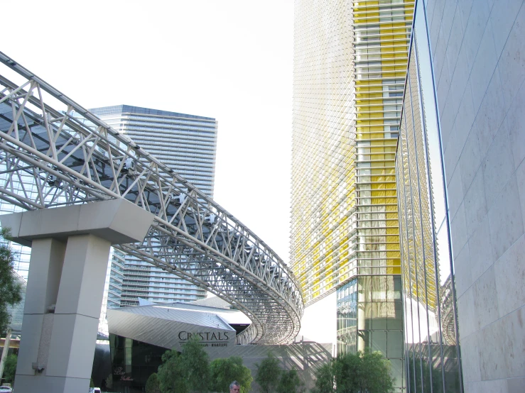 a tall building with a giant yellow sculpture on it's side