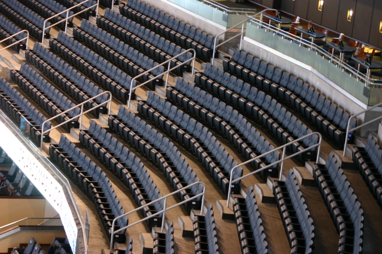 empty stadium seating with some benches and stairs