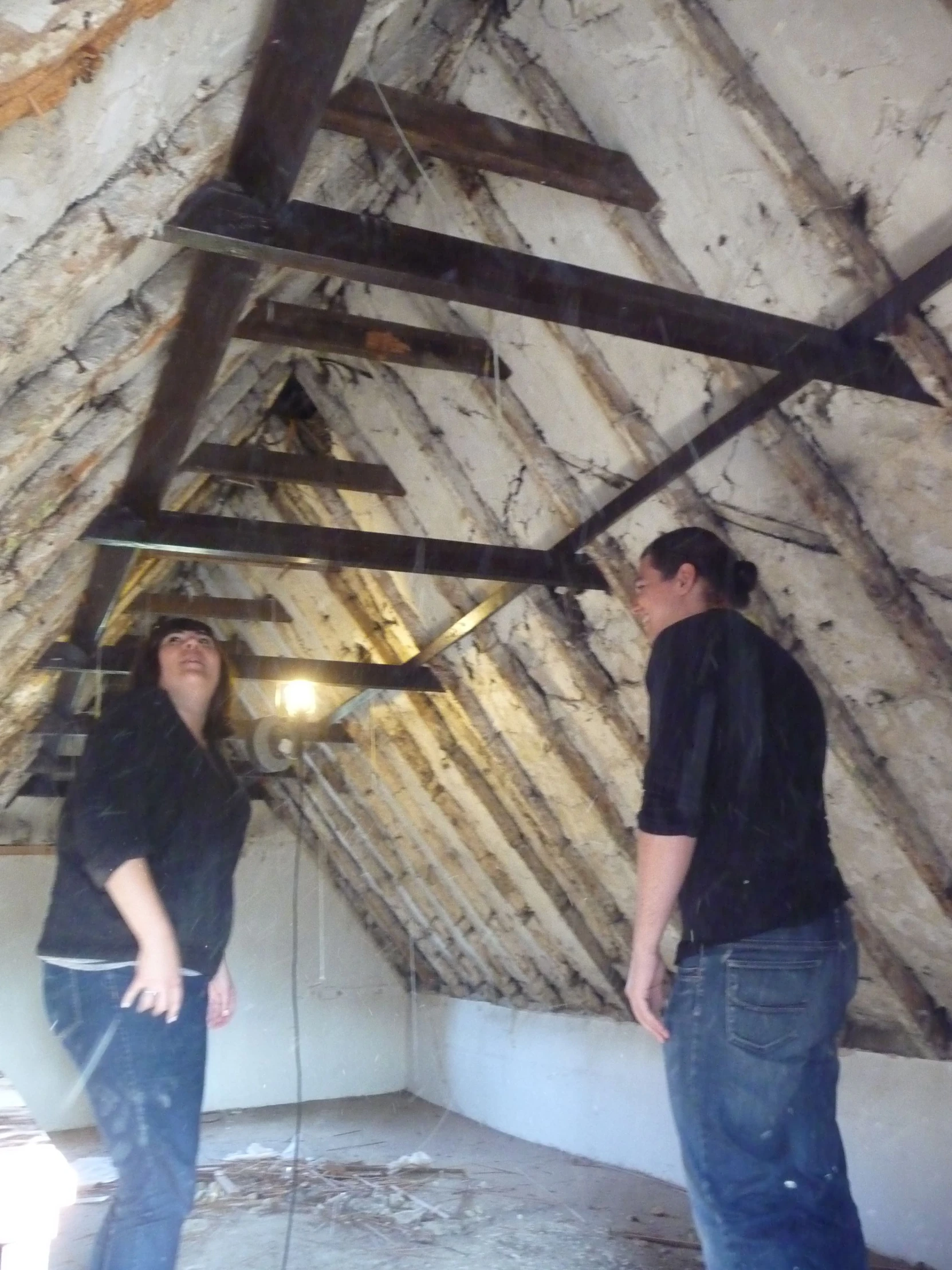 two men standing inside of an old building