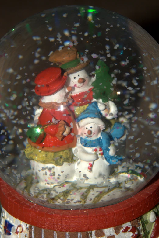 some snow men and animals inside a crystal ball