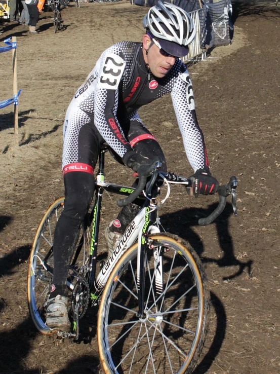 a man in bicycle gear riding on dirt