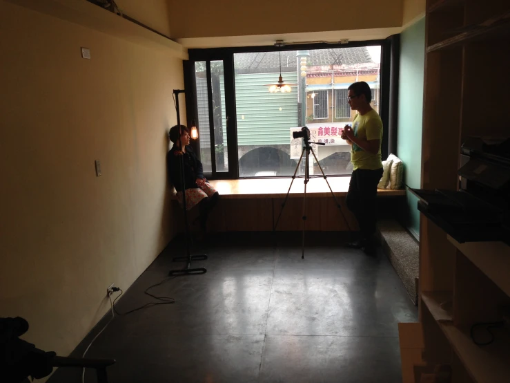 man and woman taking po with tripod in living room