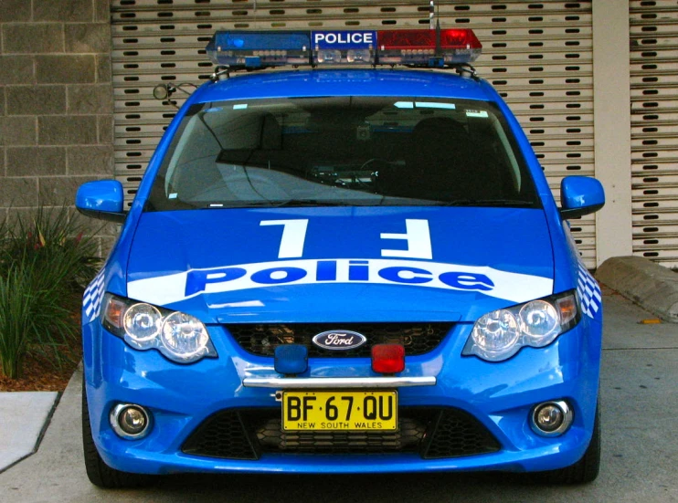 a police car is parked outside a building