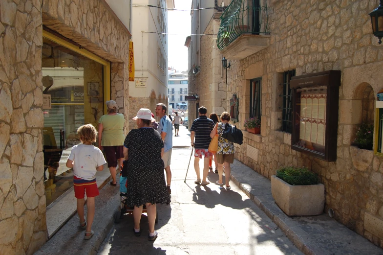 a group of people on a narrow alley