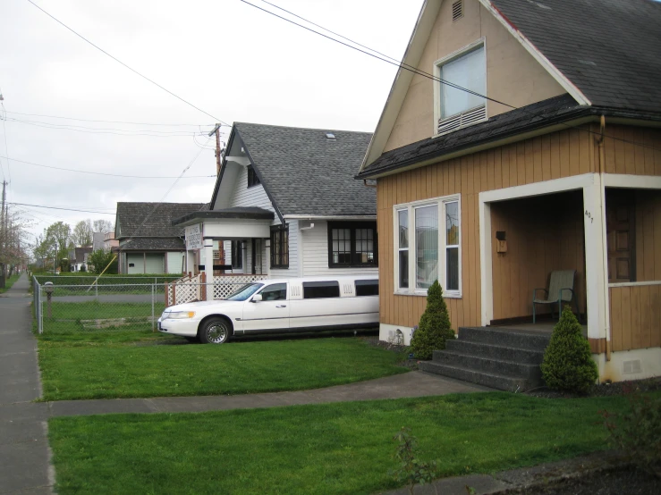 a house with a white car parked outside of it