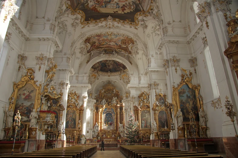 an ornate church with several golden chairs