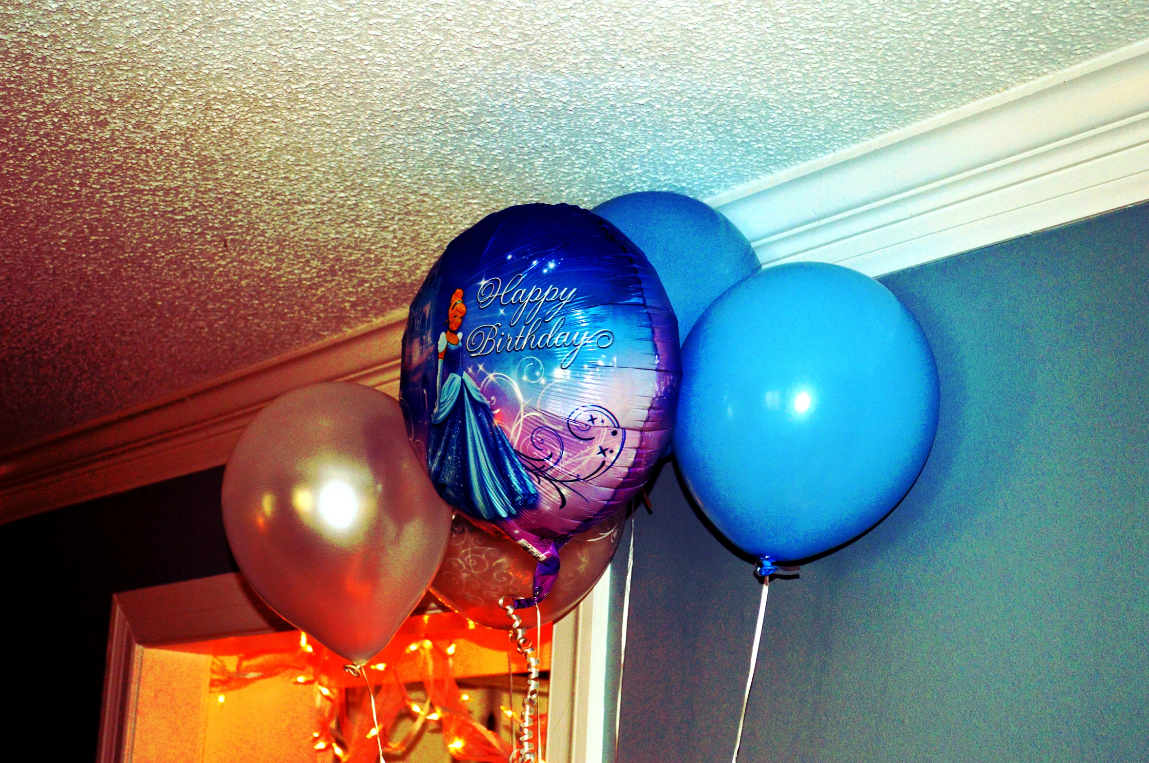 blue, white and tan balloons with a mermaid design hanging from the ceiling
