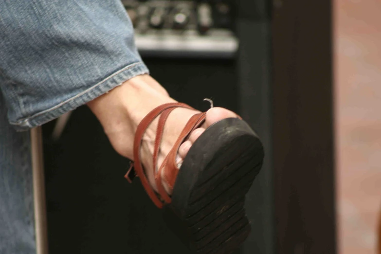 a pair of feet in sandals and a hand