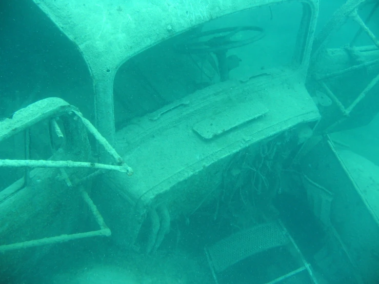 the old car that used to be underwater has been uncovered