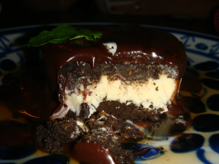 a close up of a plate of cake with chocolate and cream