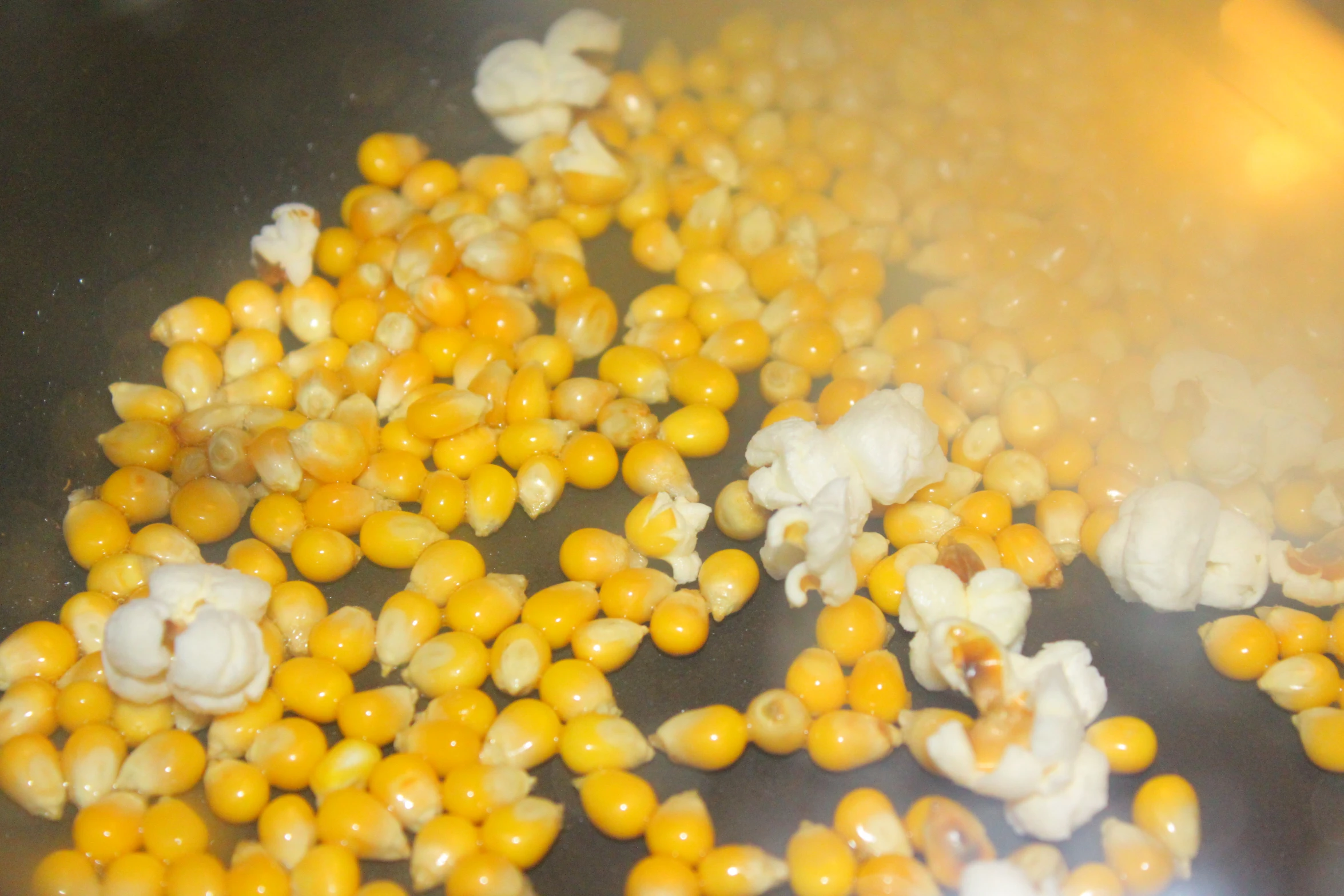 popcorn kernels and chopped kernels cooking in a set