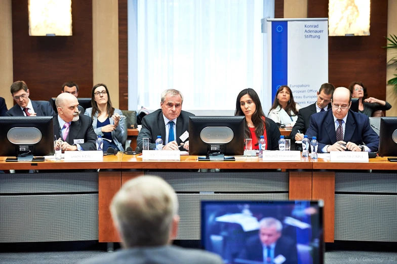 people are sitting at a table during a meeting