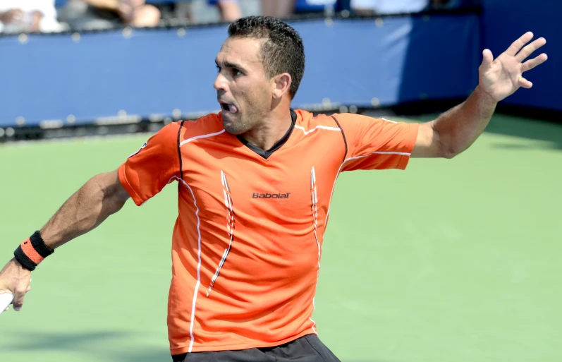 a man on a tennis court holding a racket