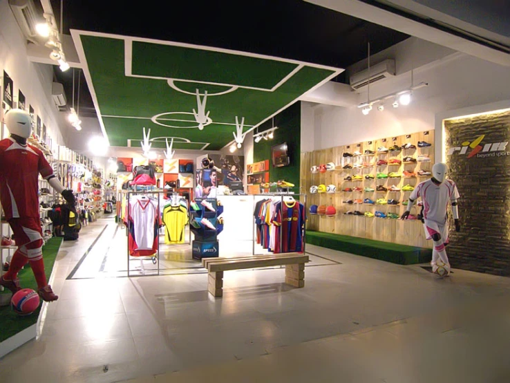 soccer fans dressed up in costumes play with soccer balls in the store's interior