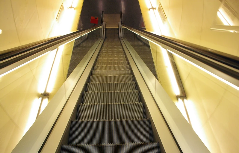 an escalator has a black striped stair