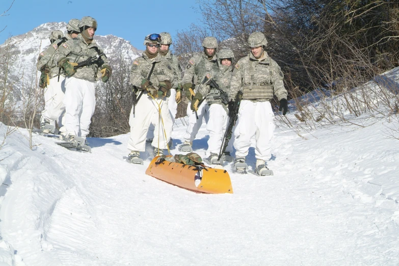 a group of soldiers in military uniforms stand on a hill