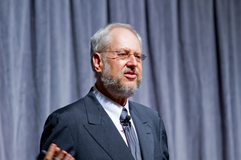 a man standing up in a business suit and tie