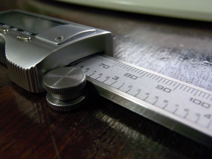 there is a tape measure near a silver scale